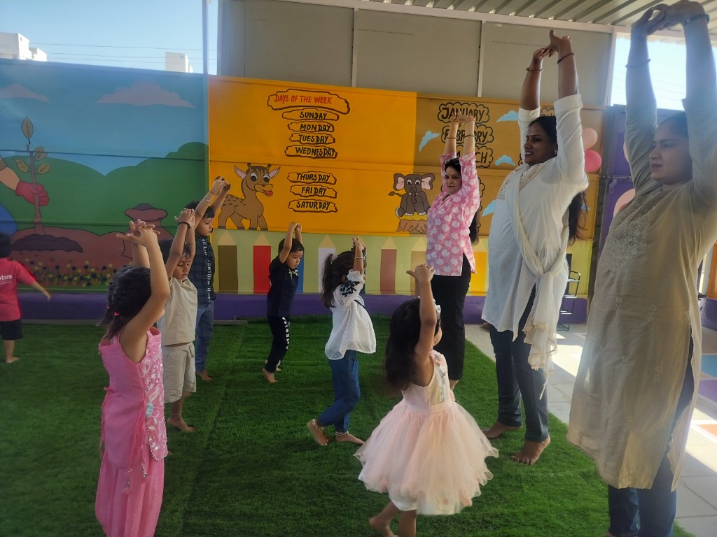 Children and teachers doing morning stretches