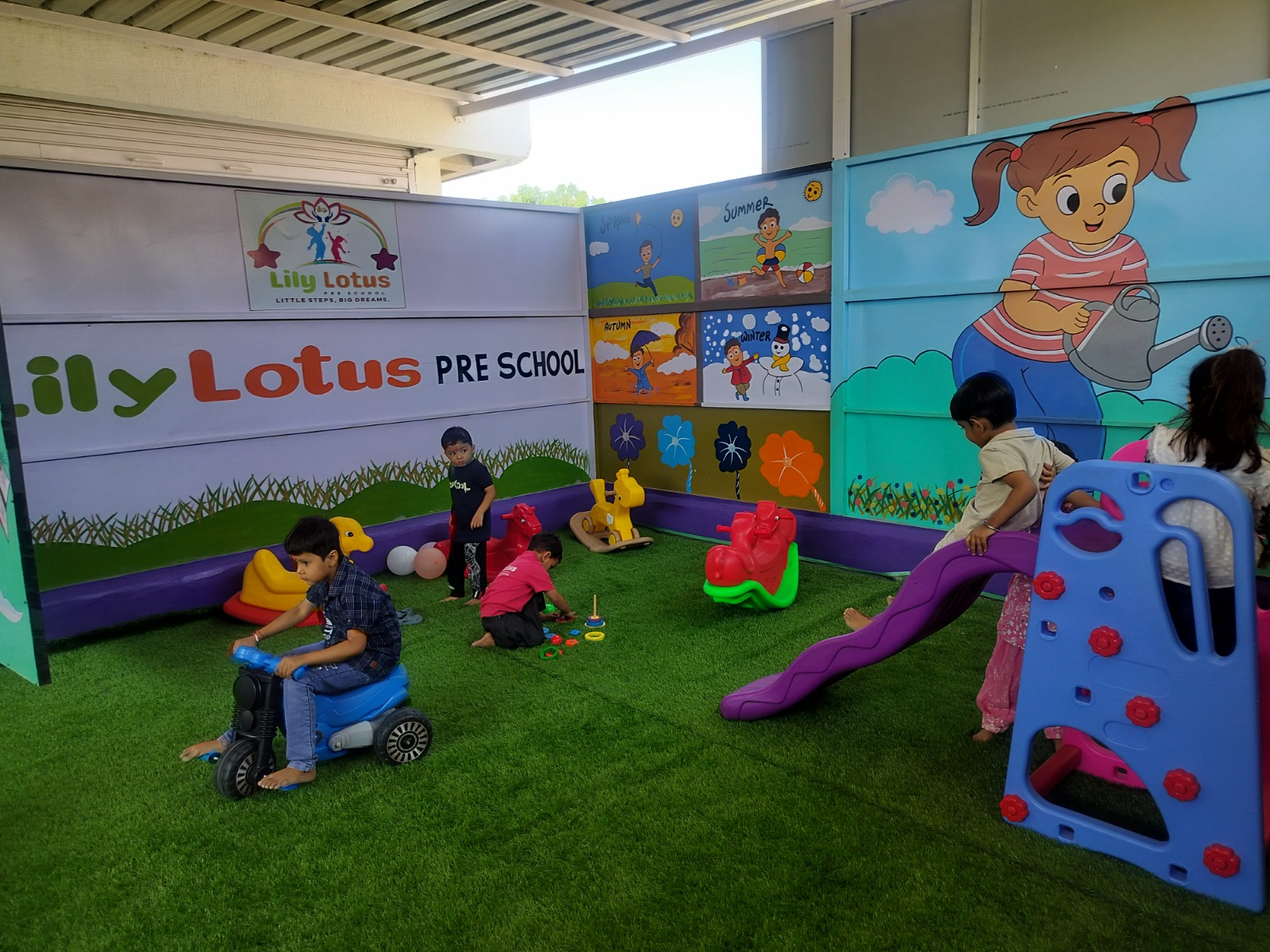 Children playing in the outdoor play area at Lily Lotus Preschool Becharaji